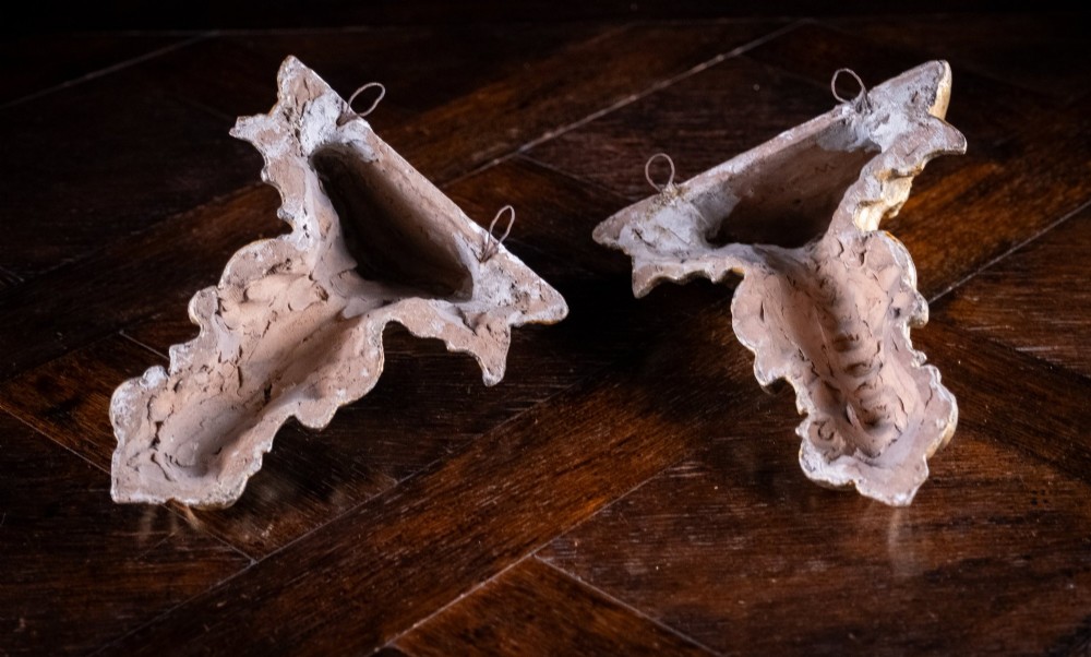 A pair of late Victorian gilt terracotta wall brackets shaped as winged sirens with decorative acanthus scrollwork bases. View XIII
