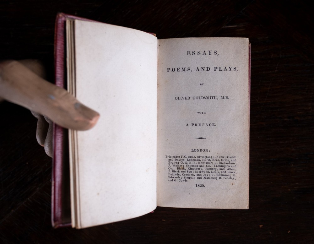 An 1821 miniature book bound in red leather featuring gilt spine tooling, raised bands, and gold lettering. View XI