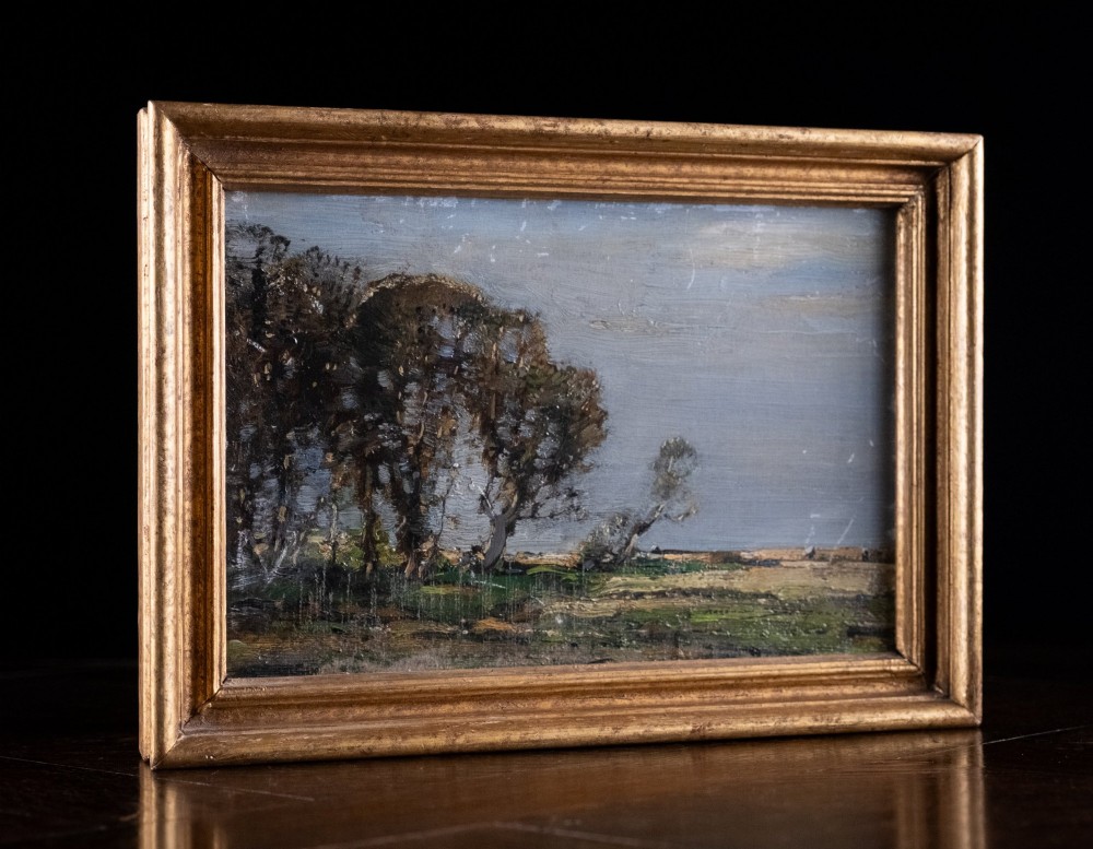 An antique oil painting on board portraying a stand of trees in an open landscape within a moulded gilt wooden frame. View VI