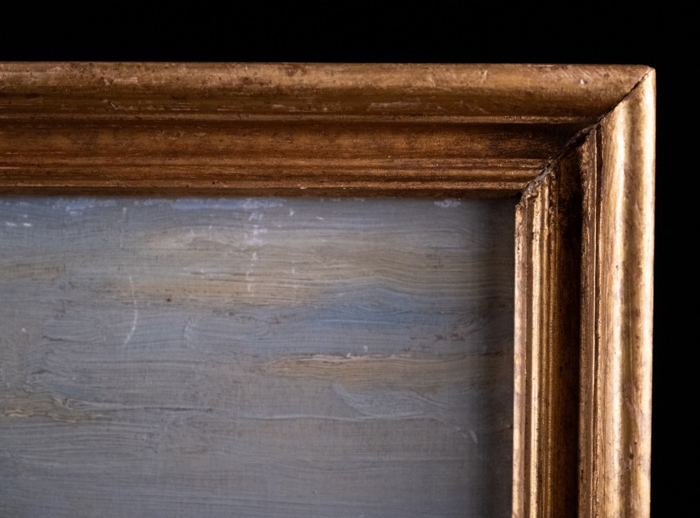 An antique oil painting on board portraying a stand of trees in an open landscape within a moulded gilt wooden frame. View VIII
