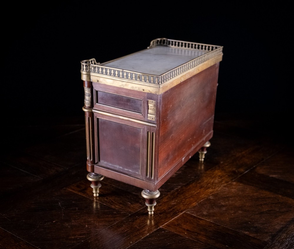 A miniature Louis XVI style mahogany chest of three drawers featuring a white marble top, pierced brass gallery, and metal drawer handles. View XI