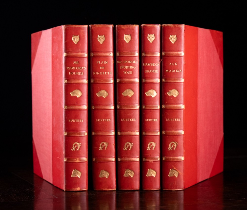 A five-volume set of red books featuring gilt spine lettering and embossed animal motifs.