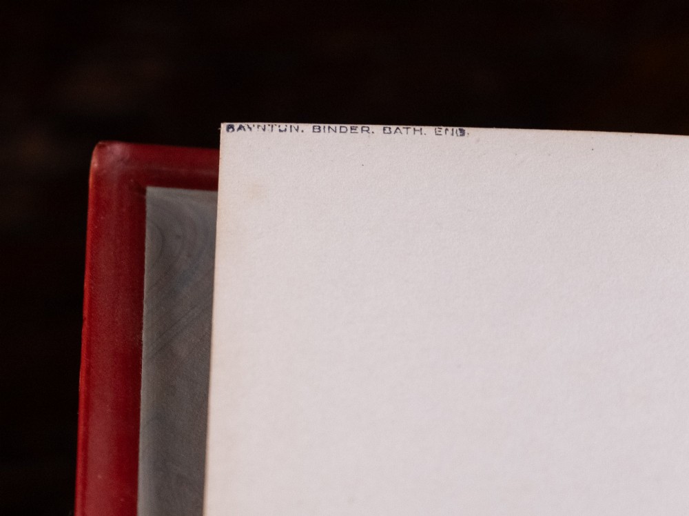 A five-volume set of red books featuring gilt spine lettering and embossed animal motifs. View VIII