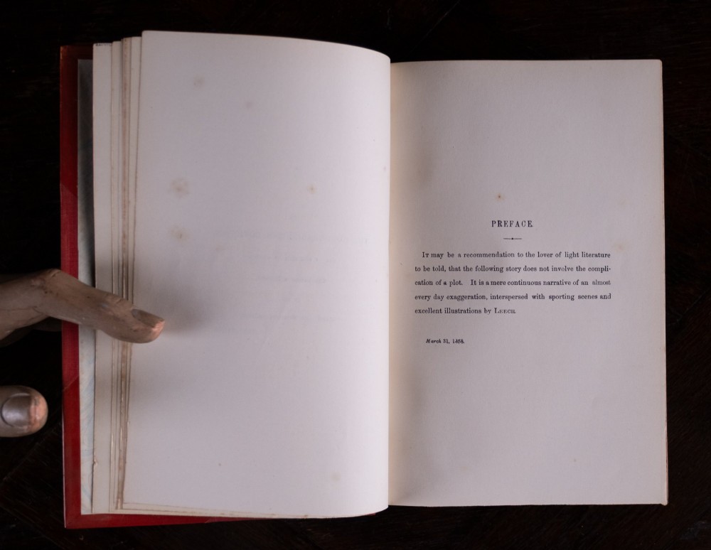 A five-volume set of red books featuring gilt spine lettering and embossed animal motifs. View IX