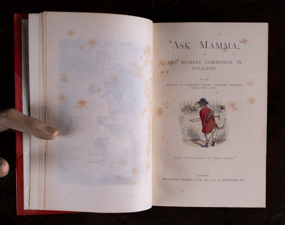 A five-volume set of red books featuring gilt spine lettering and embossed animal motifs. View X