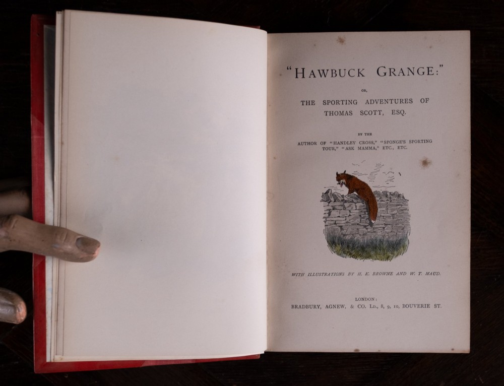 A five-volume set of red books featuring gilt spine lettering and embossed animal motifs. View XIV