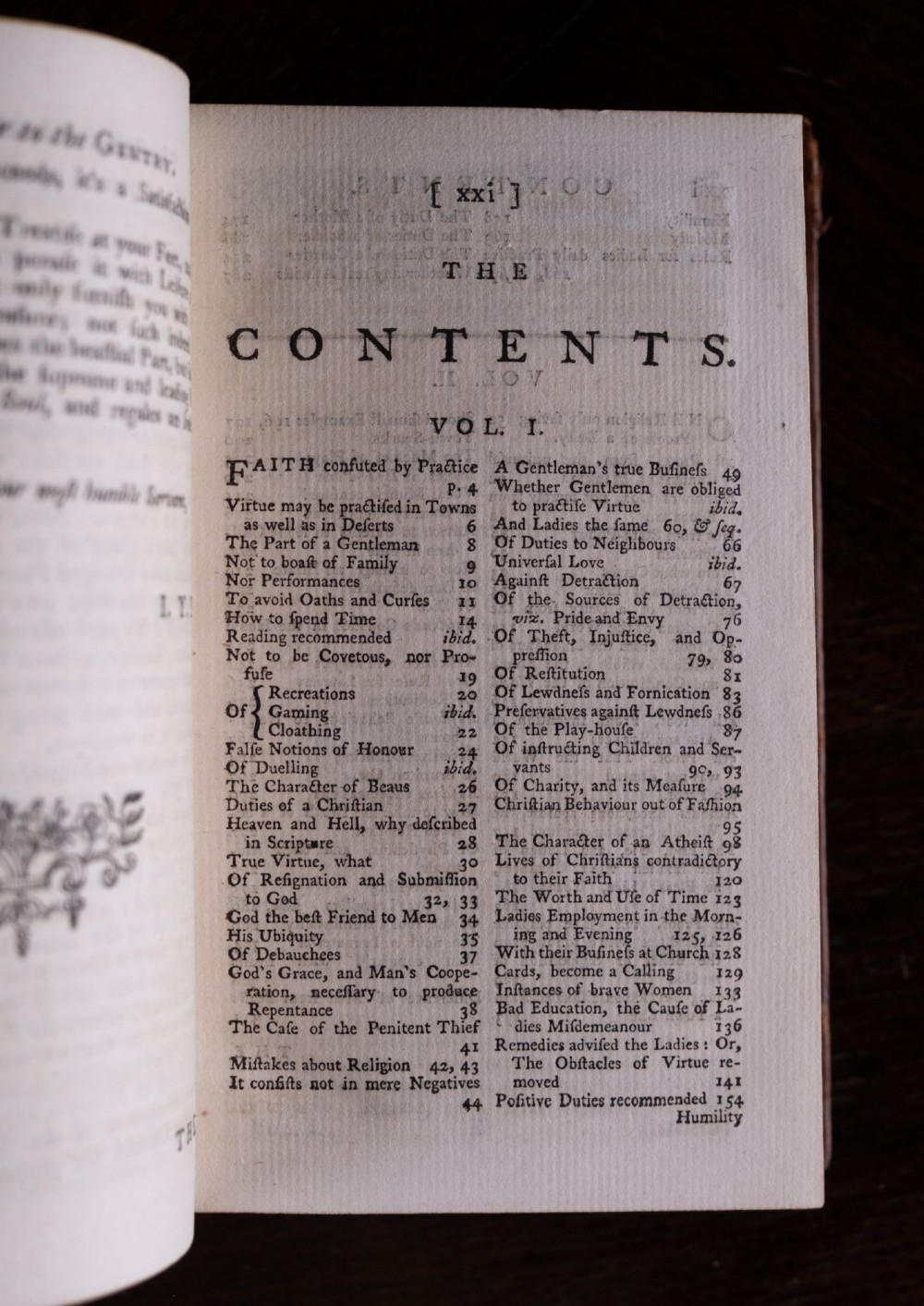 A two-volume set of 18th-century leather-bound books featuring gilt-tooled spine details and raised bands standing vertically. View X