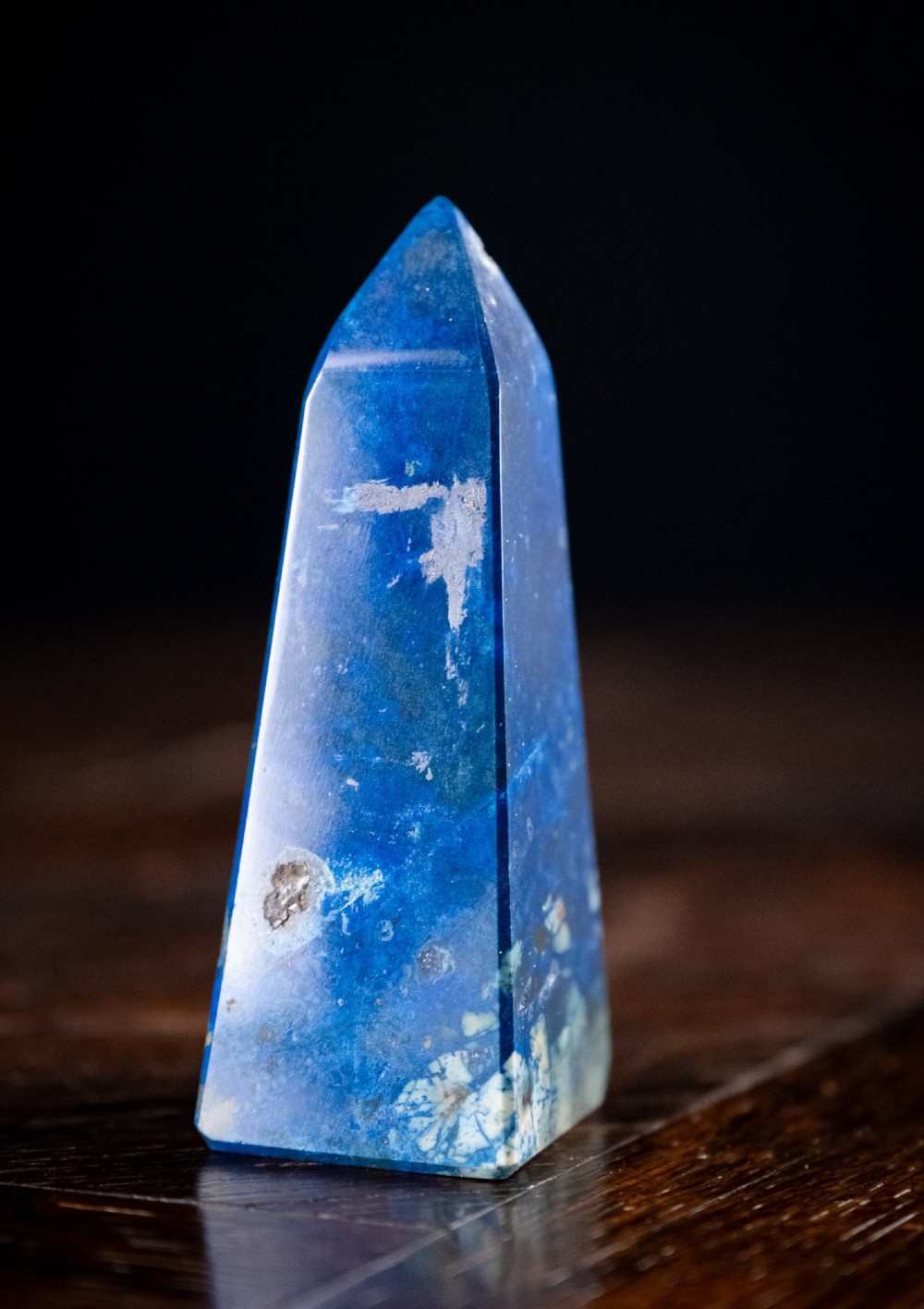 A polished deep blue lapis lazuli obelisk featuring incised gold lettering that reads Interlacken 1876. View V