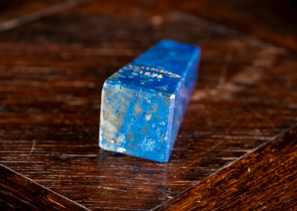 A polished deep blue lapis lazuli obelisk featuring incised gold lettering that reads Interlacken 1876. View VII