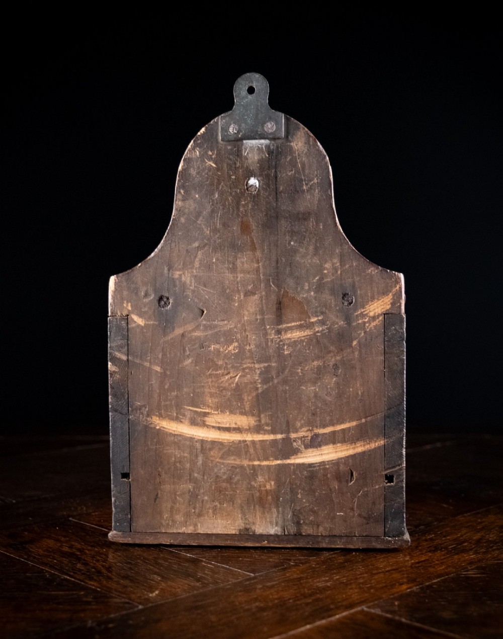 A nineteenth-century reddish-brown painted wooden wall-hanging salt box featuring gilt lettering reading SALT, a sloping hinged lid, and a small bottom drawer. View XII
