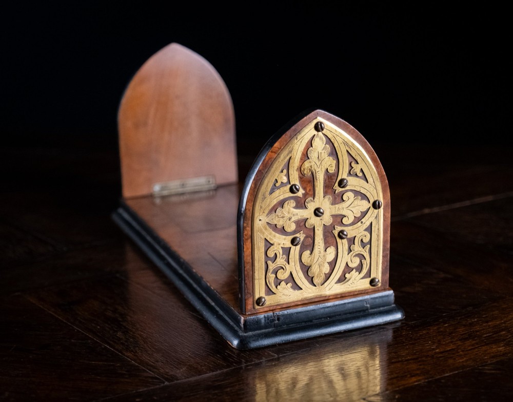 An antique dark walnut extending book slide featuring arched gothic ends detailed with pierced and engraved brass mounts. View III