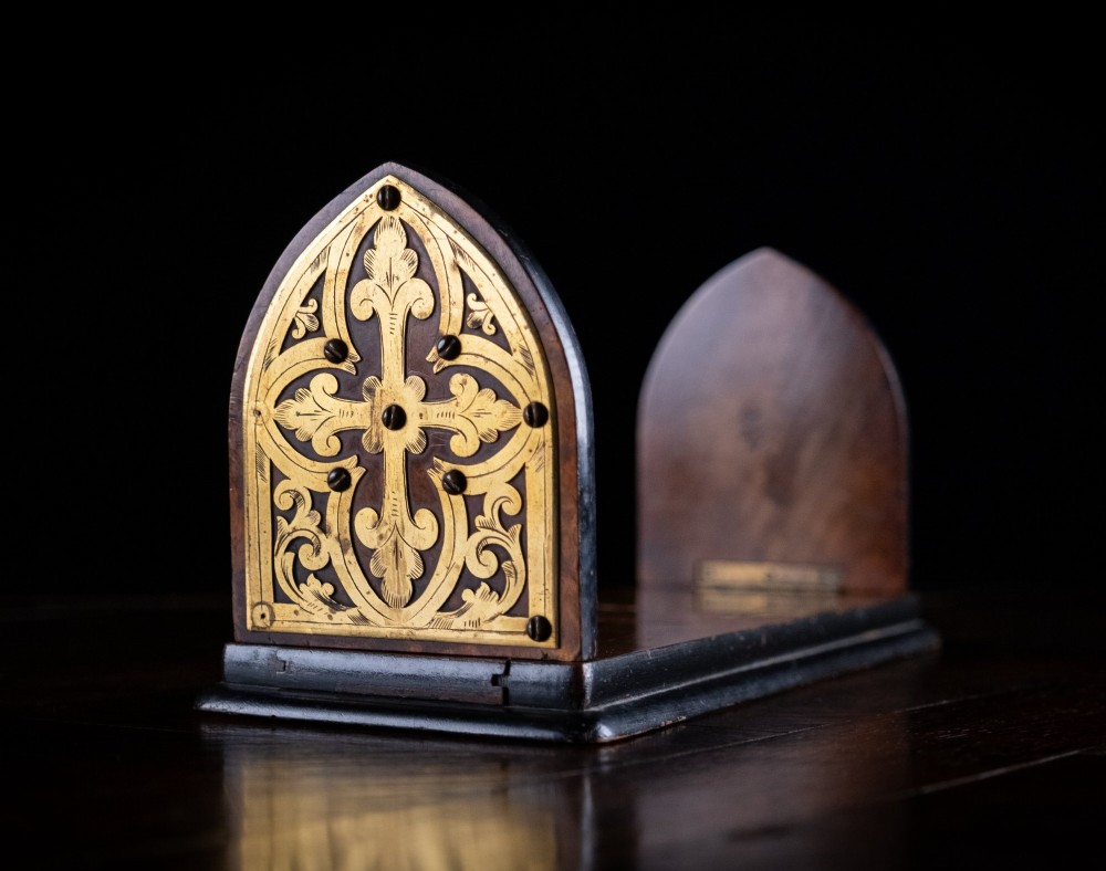 An antique dark walnut extending book slide featuring arched gothic ends detailed with pierced and engraved brass mounts. View IV
