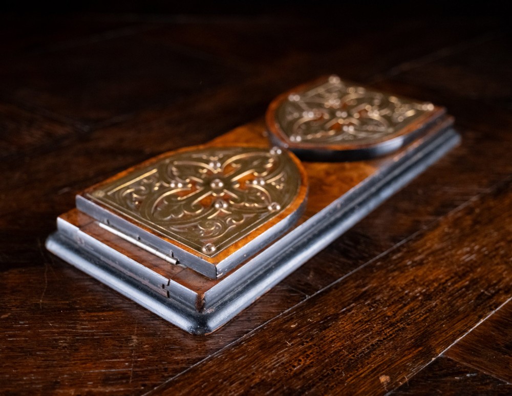 An antique dark walnut extending book slide featuring arched gothic ends detailed with pierced and engraved brass mounts. View IX
