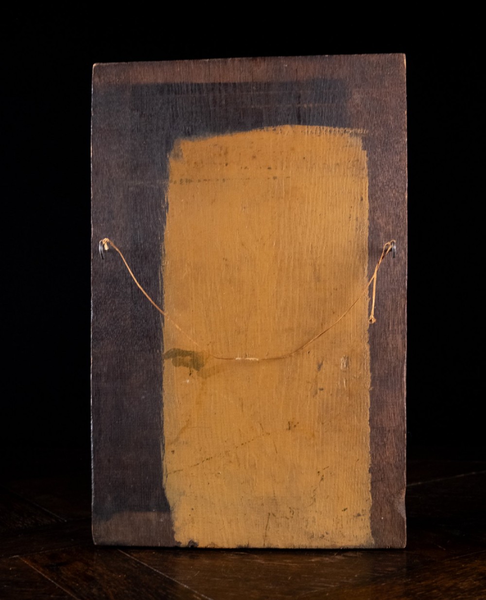 A rectangular dark oak timber panel featuring a high-relief hand carving of a crouching dragon with a feathered neck and curved tail. View V