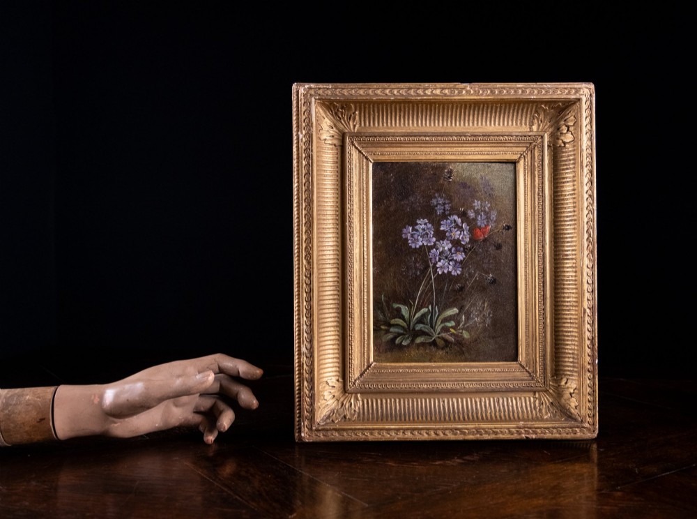 A 19th-century oil painting on canvas depicting purple flowers and a small red butterfly set within an ornate fluted gilt frame. View III