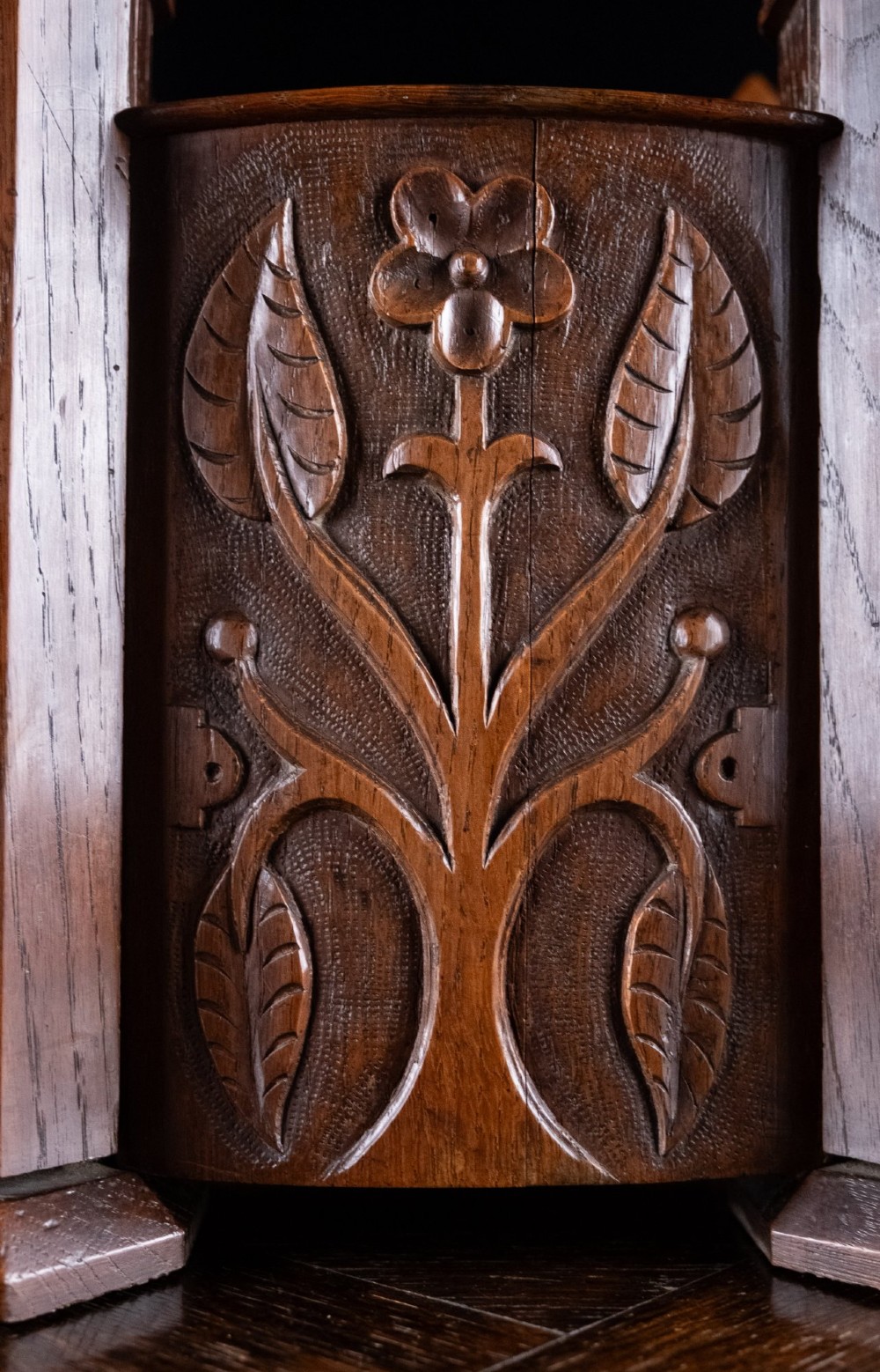 A 19th-century carved oak jewellery box designed like a castle with four corner turrets, floral relief panels, and small drawers. View VI