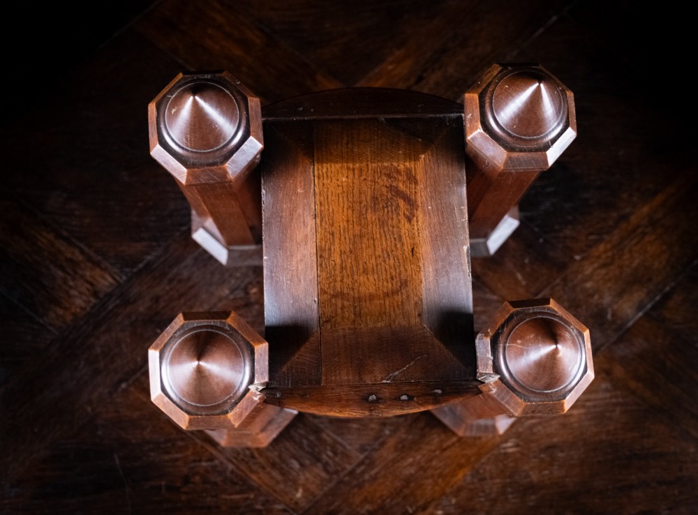 A 19th-century carved oak jewellery box designed like a castle with four corner turrets, floral relief panels, and small drawers. View XII