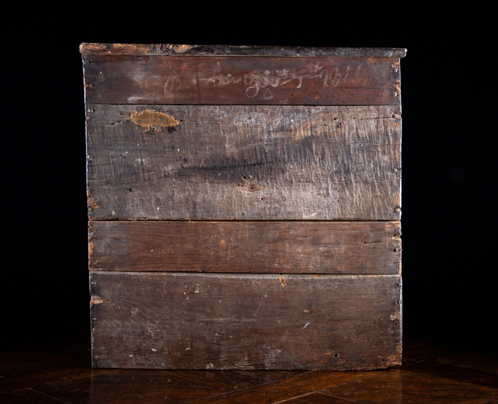 An 18th-century dark oak tabletop chest of drawers featuring seven multi-sized drawers with brass knob handles and a brass keyhole escutcheon. View XI