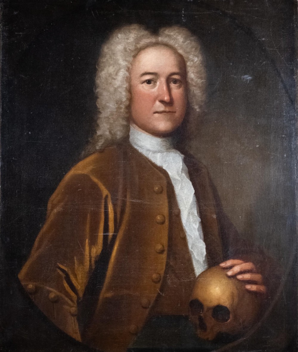 An early eighteenth-century oil portrait of a gentleman in a wig and brown coat with his hand resting on a skull.