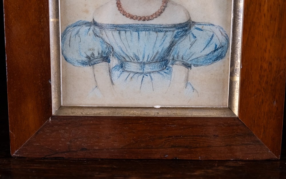 An early 19th-century watercolour portrait miniature depicting a young girl with dark curls in a blue dress, displayed in a dark wood frame. View VI
