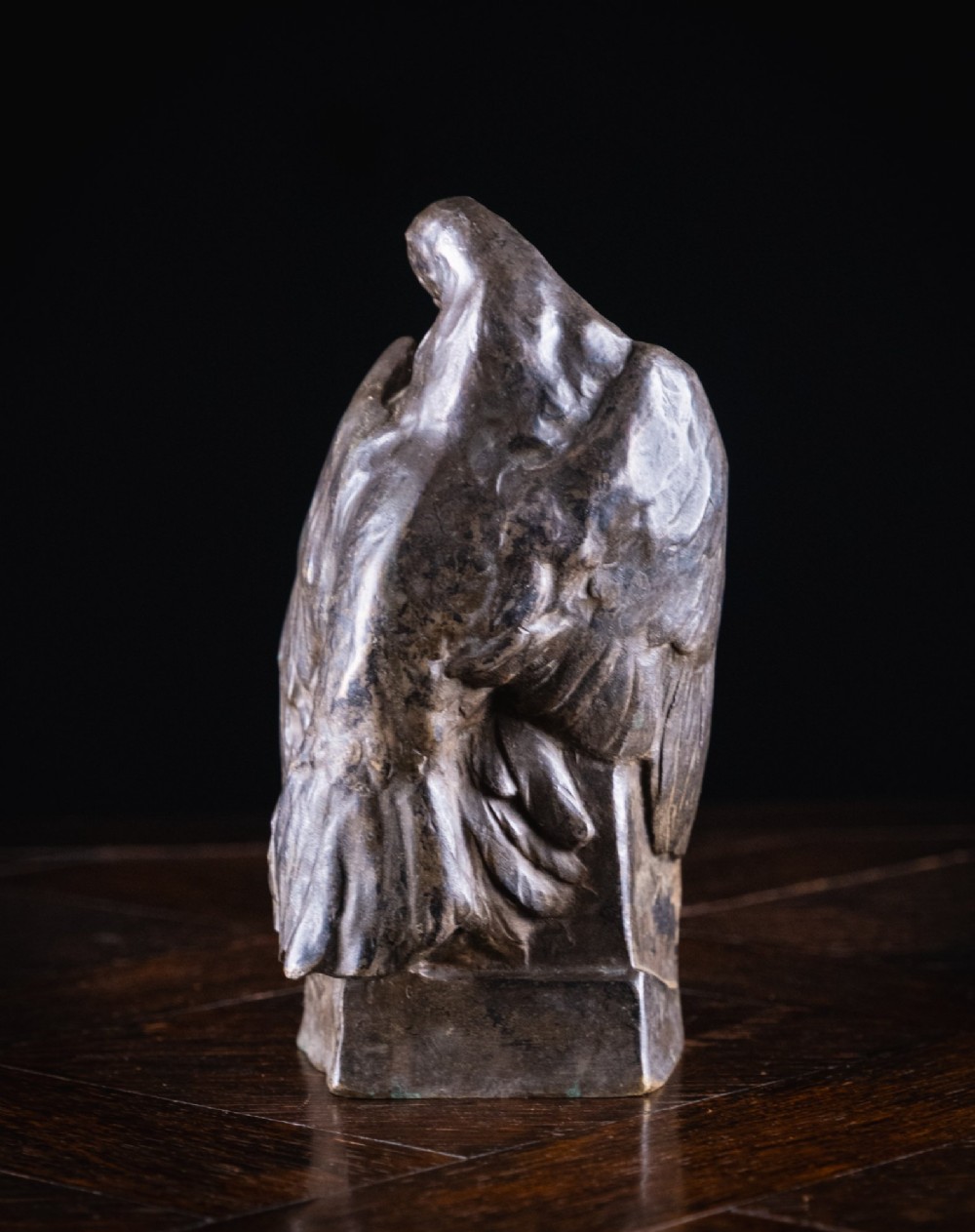A patinated nickel bronze sculpture depicting two pigeons embracing atop a geometric plinth. View VI