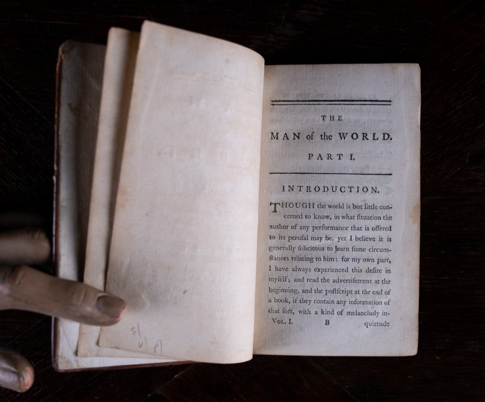 A two-volume set of 1773 brown leather-bound books titled The Man of the World with gilt lettering on the spines. View IX