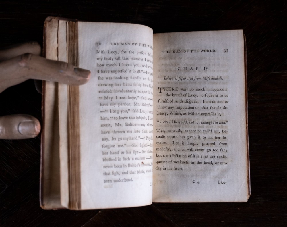 A two-volume set of 1773 brown leather-bound books titled The Man of the World with gilt lettering on the spines. View X