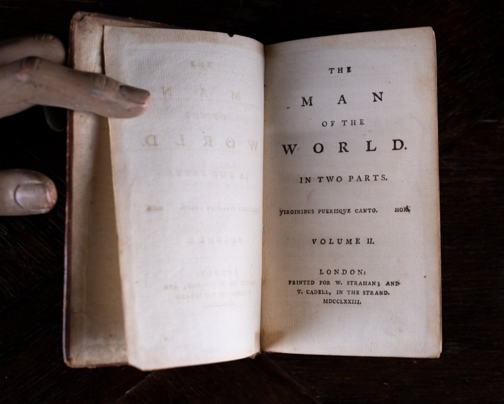 A two-volume set of 1773 brown leather-bound books titled The Man of the World with gilt lettering on the spines. View XII