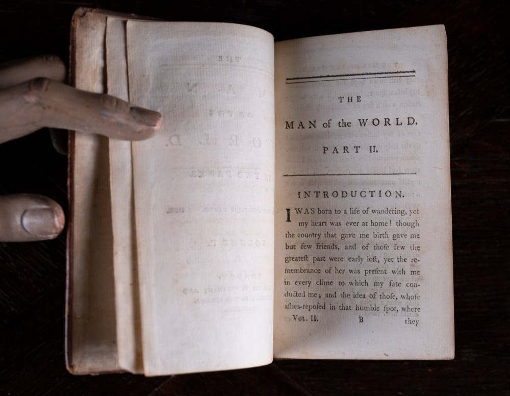 A two-volume set of 1773 brown leather-bound books titled The Man of the World with gilt lettering on the spines. View XIII