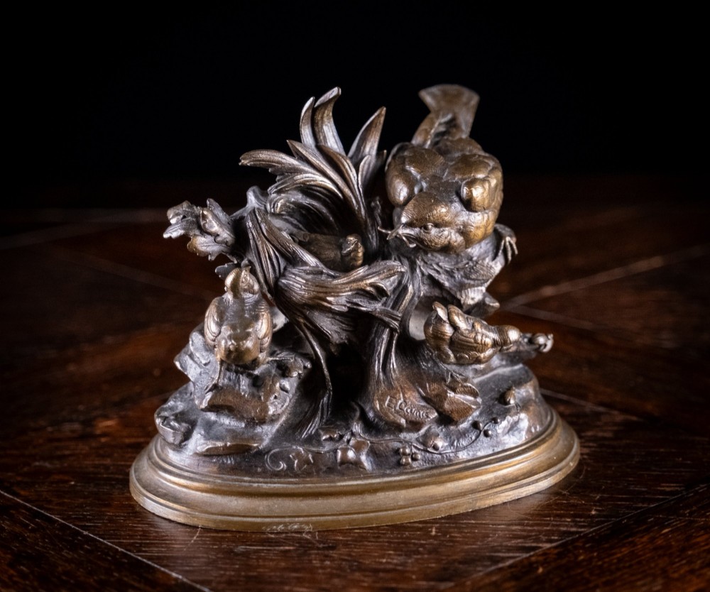 A 19th-century patinated bronze sculpture by Louis Emile Cana depicting an adult bird perched beside a nest with fledglings on a naturalist base.