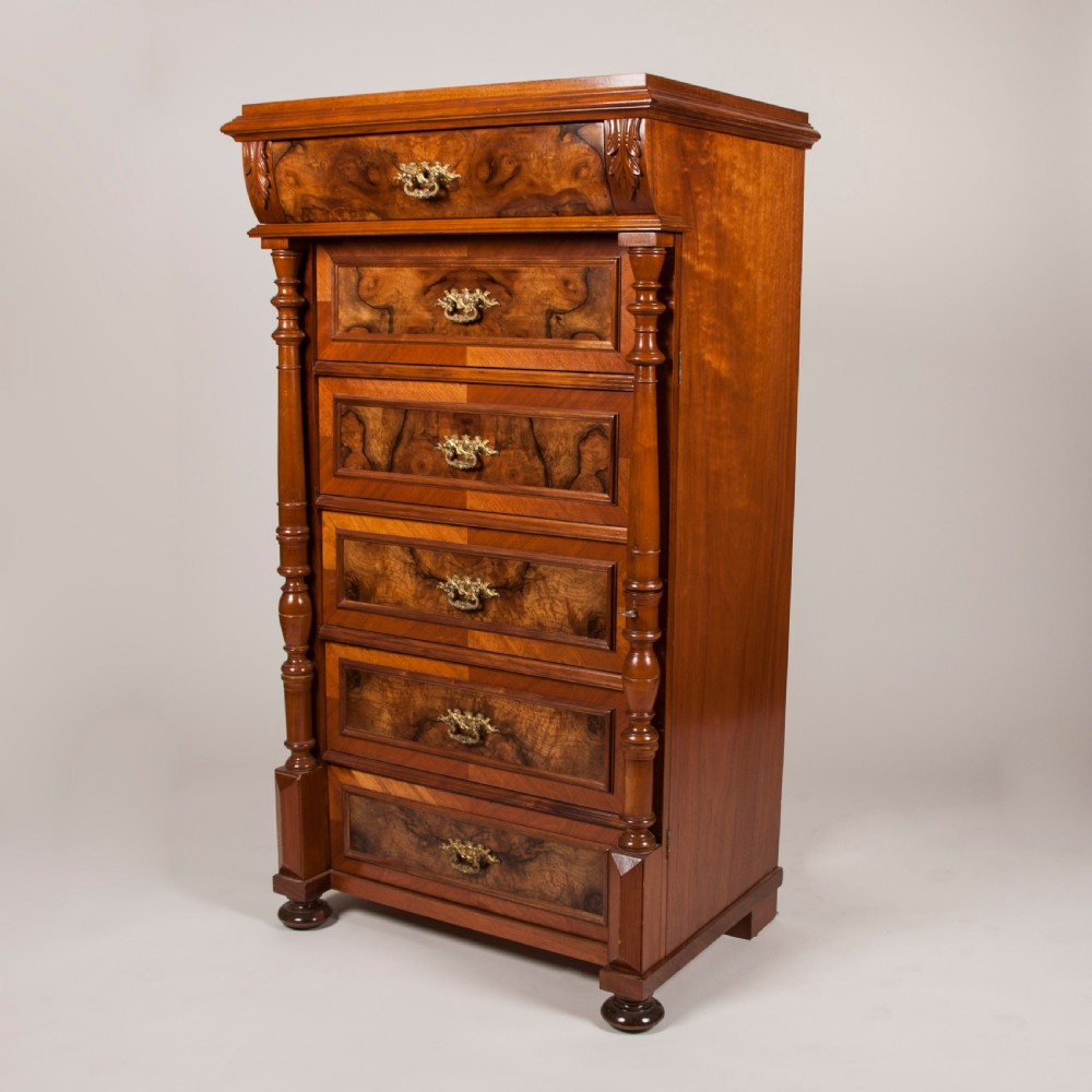 A tall 19th-century burr walnut chest of six drawers featuring ornate gilded brass handles, flanking turned pilasters, and bun feet. View III