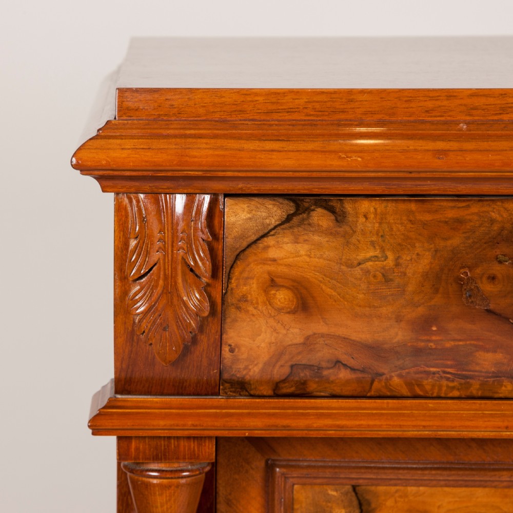 A tall 19th-century burr walnut chest of six drawers featuring ornate gilded brass handles, flanking turned pilasters, and bun feet. View VII