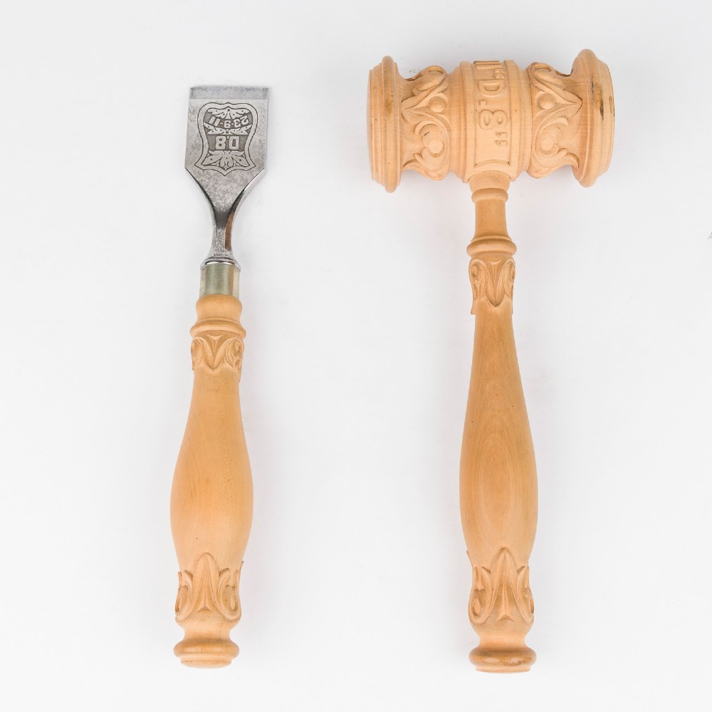 An open Edwardian carved oak presentation casket lined in navy blue velvet, containing a carved wooden ceremonial mallet and chisel set with an engraved silver plaque. View IV