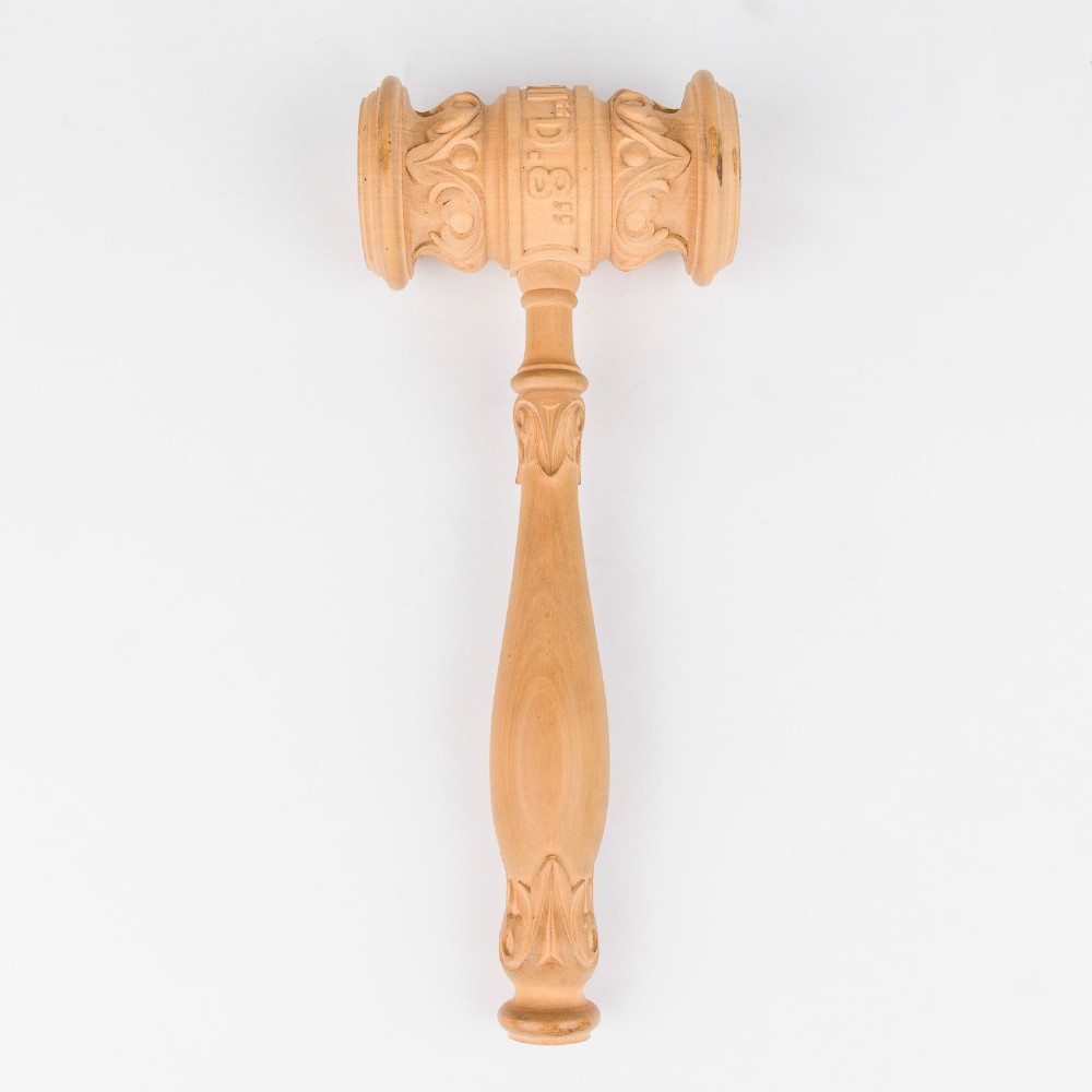 An open Edwardian carved oak presentation casket lined in navy blue velvet, containing a carved wooden ceremonial mallet and chisel set with an engraved silver plaque. View IX
