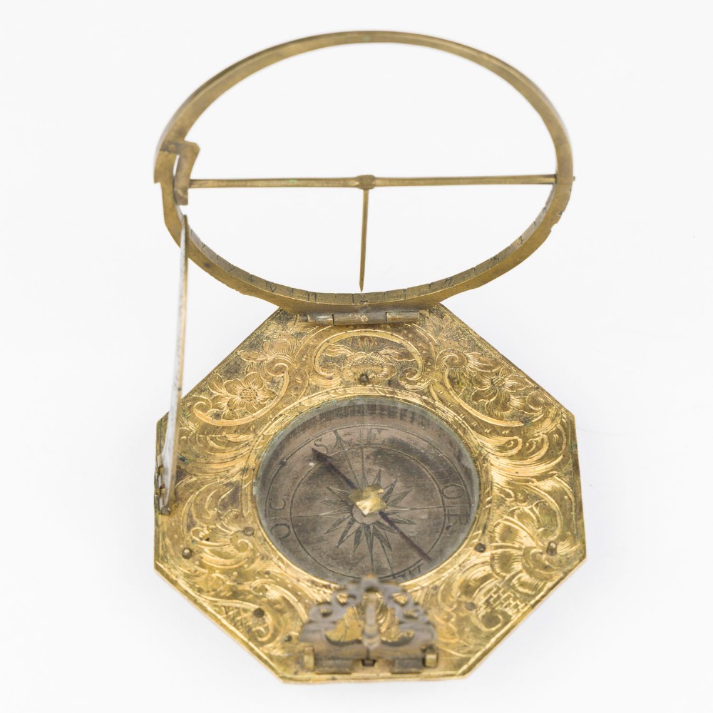 An 18th-century engraved brass octagonal pocket sundial with an inset glass-covered compass, an adjustable latitude arc, and a hinged hour ring. View III