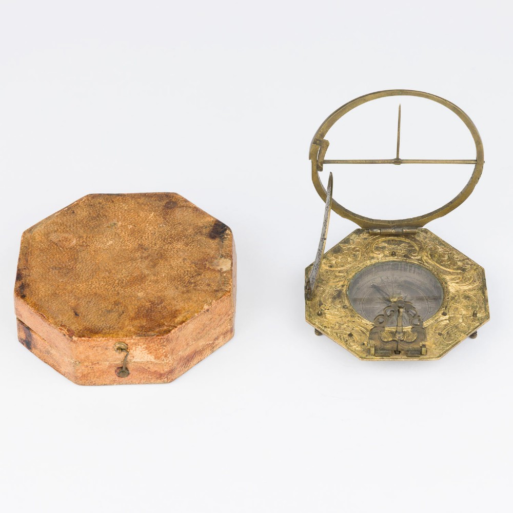 An 18th-century engraved brass octagonal pocket sundial with an inset glass-covered compass, an adjustable latitude arc, and a hinged hour ring. View VIII