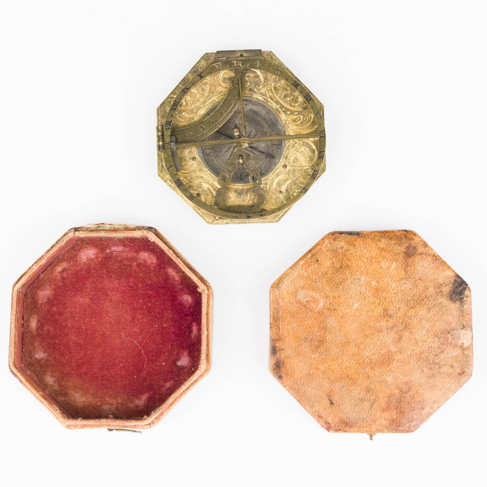 An 18th-century engraved brass octagonal pocket sundial with an inset glass-covered compass, an adjustable latitude arc, and a hinged hour ring. View IX