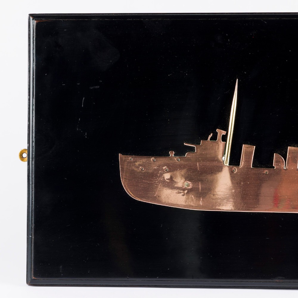 A rectangular black lacquered wooden plaque displaying a copper cutout profile of HMS Tartar 1906 with a small brass title tag below. View IV