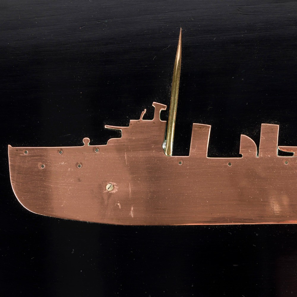 A rectangular black lacquered wooden plaque displaying a copper cutout profile of HMS Tartar 1906 with a small brass title tag below. View V