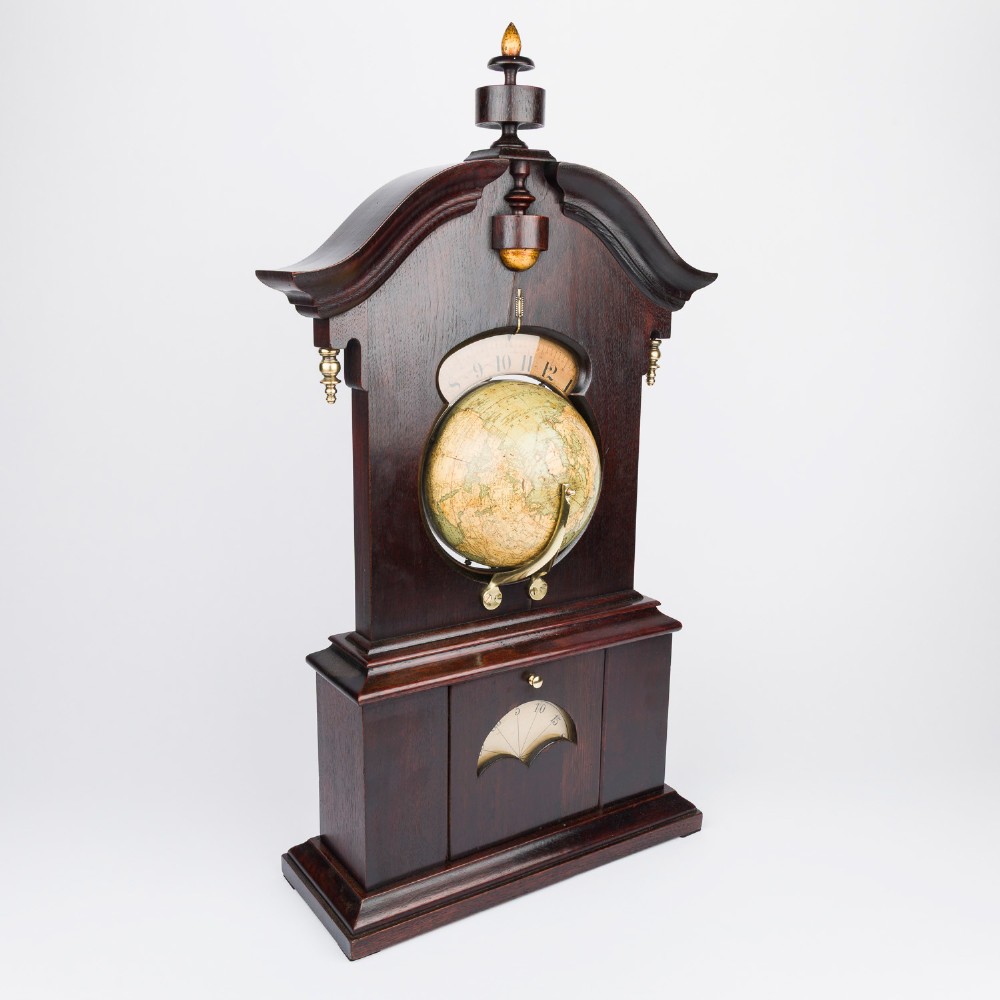 A dark mahogany Timby solar timepiece featuring an embedded central globe beneath a curved hour scale and brass finials. View II