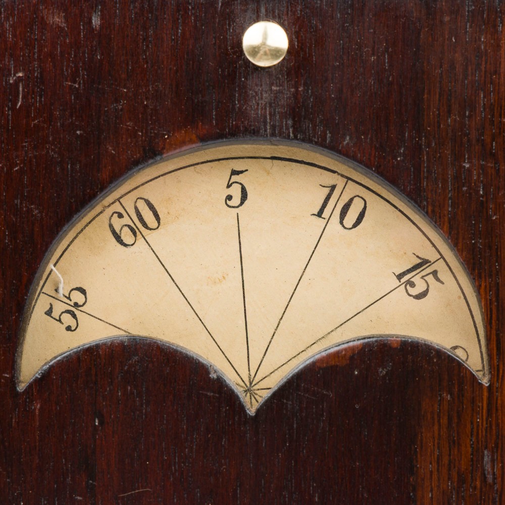 A dark mahogany Timby solar timepiece featuring an embedded central globe beneath a curved hour scale and brass finials. View VI