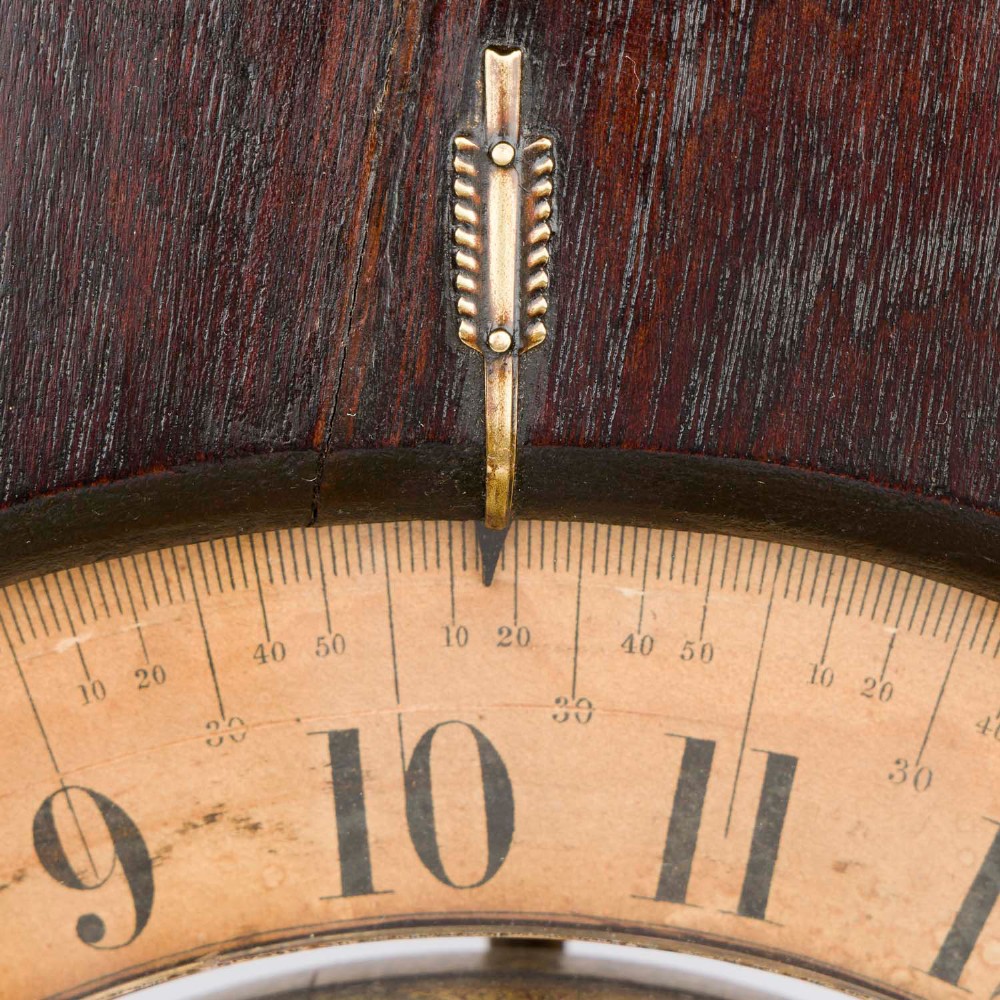 A dark mahogany Timby solar timepiece featuring an embedded central globe beneath a curved hour scale and brass finials. View VII