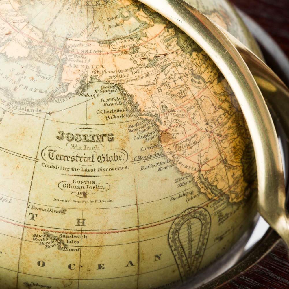 A dark mahogany Timby solar timepiece featuring an embedded central globe beneath a curved hour scale and brass finials. View VIII
