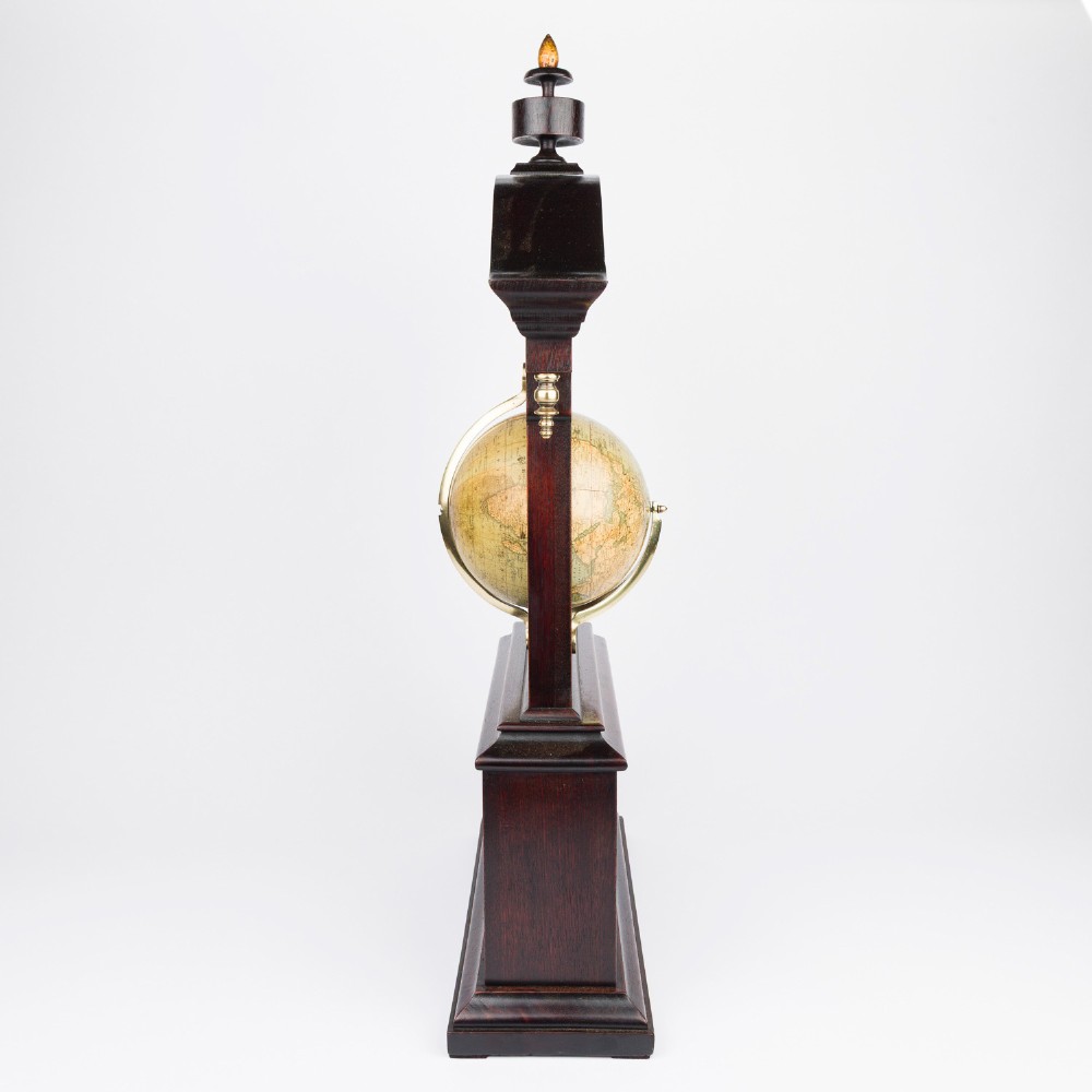 A dark mahogany Timby solar timepiece featuring an embedded central globe beneath a curved hour scale and brass finials. View XI