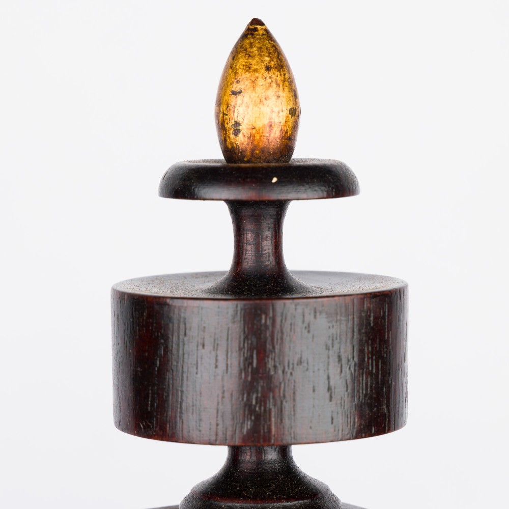 A dark mahogany Timby solar timepiece featuring an embedded central globe beneath a curved hour scale and brass finials. View XIII