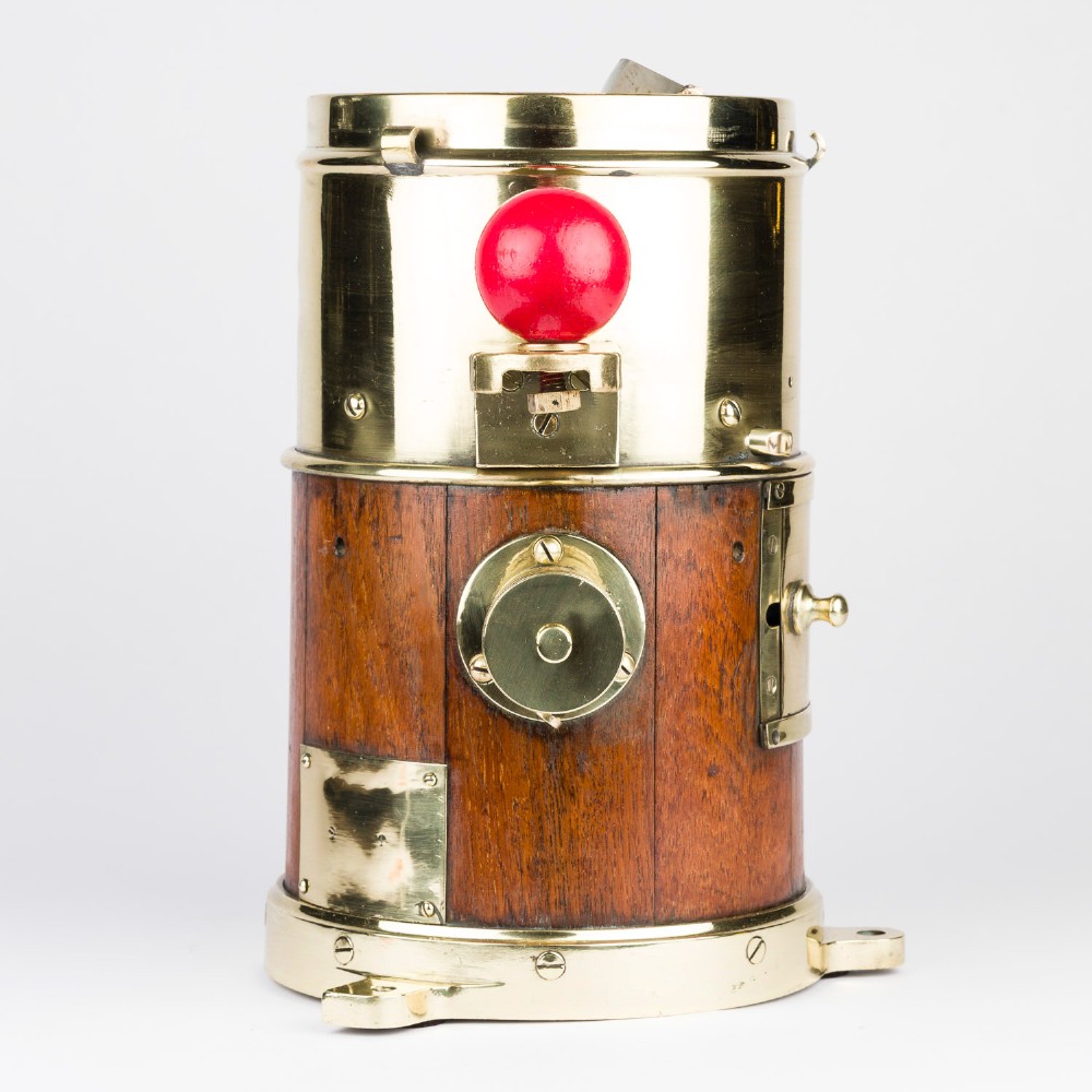 A polished brass and mahogany submarine binnacle featuring a hinged hood with carrying handle, a glass viewing lens, and extended side arms holding red and green painted iron spheres. View VIII