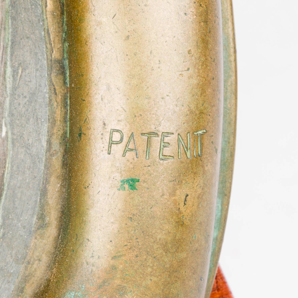 An antique Siebe Gorman copper and brass deep-sea diving helmet with a central circular viewport and lateral window grilles. View V
