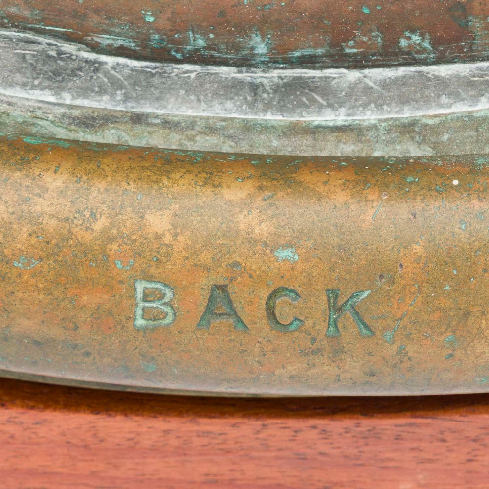 An antique Siebe Gorman copper and brass deep-sea diving helmet with a central circular viewport and lateral window grilles. View VII