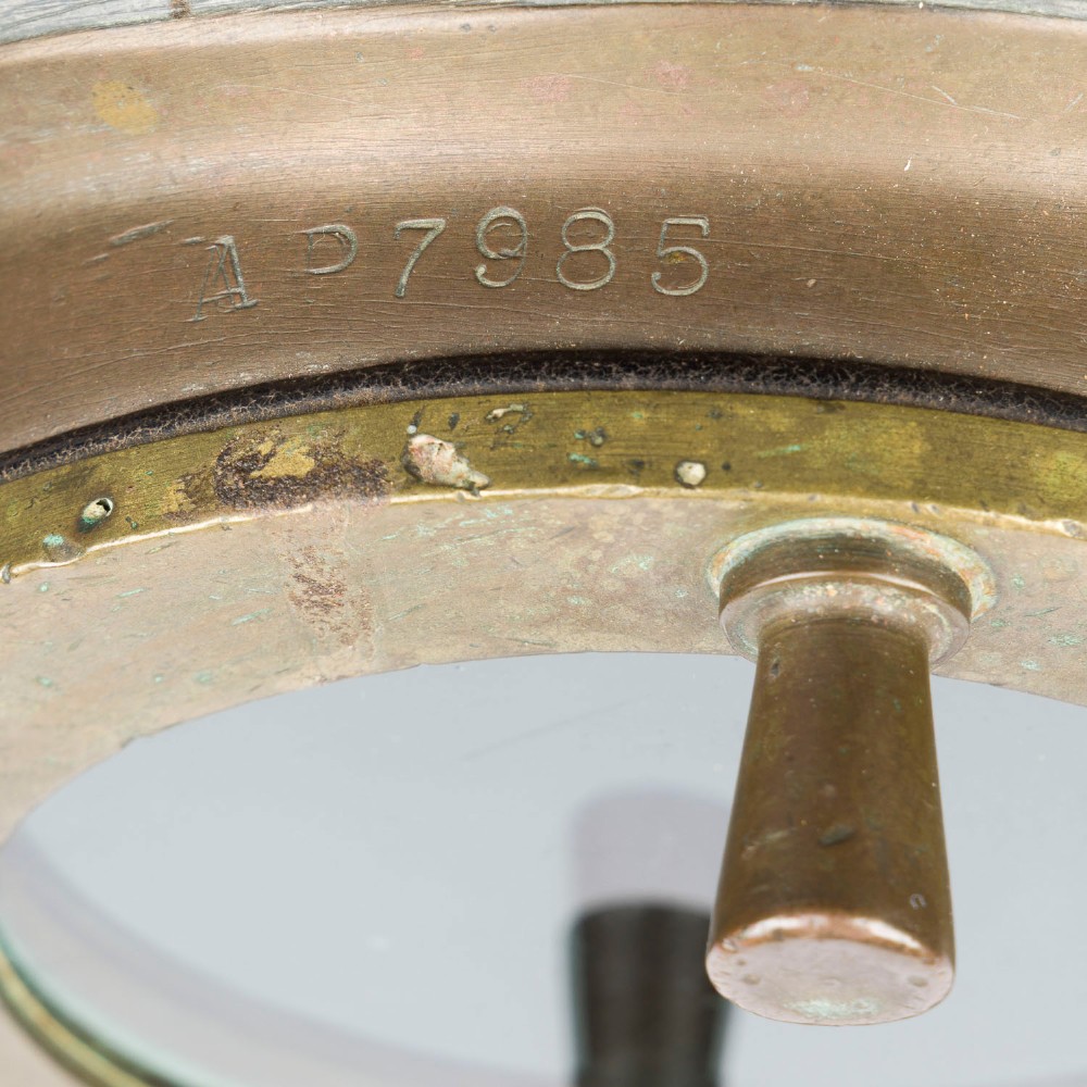 An antique Siebe Gorman copper and brass deep-sea diving helmet with a central circular viewport and lateral window grilles. View IX