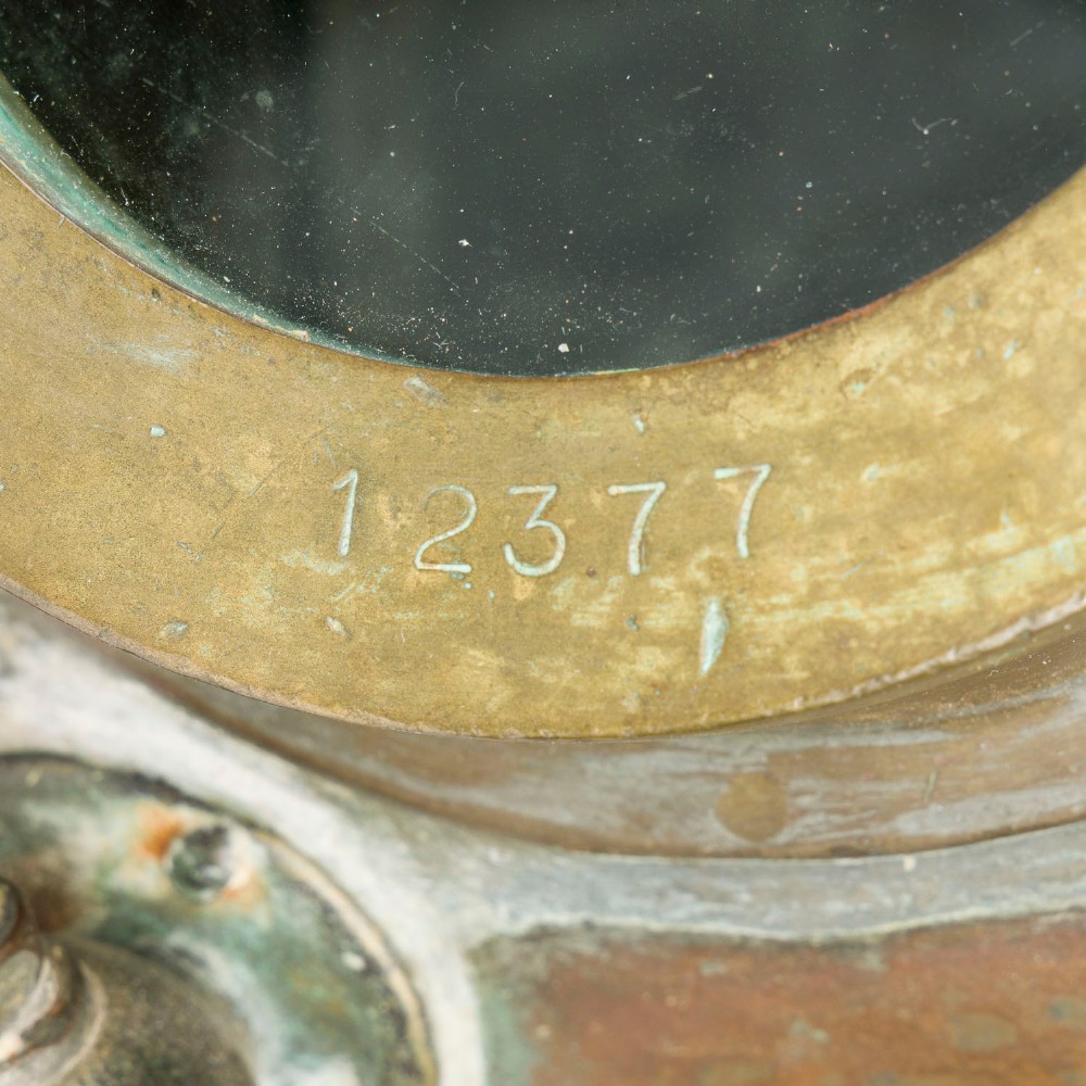 An antique Siebe Gorman copper and brass deep-sea diving helmet with a central circular viewport and lateral window grilles. View XIII